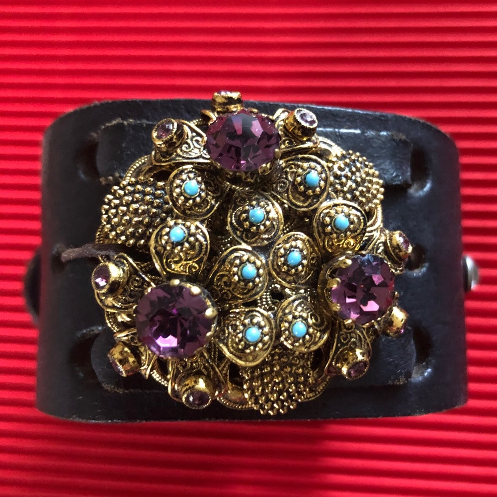 Upcycled black leather cuff with antique brooch.